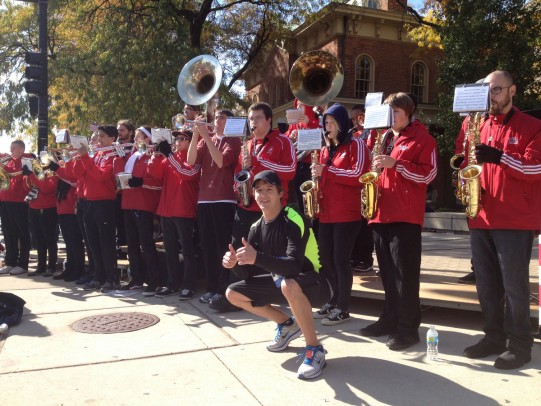 Stephen Ragalie stops for a photo with the Pep Band at Mile 17.
