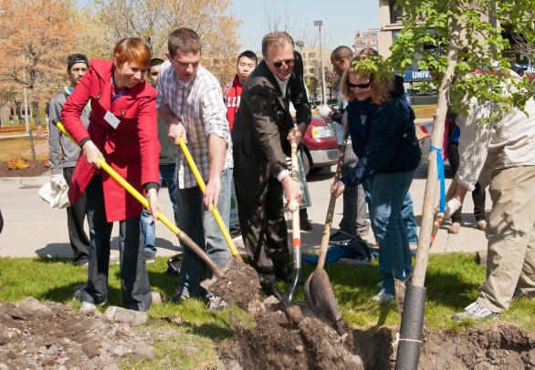 Students, staff and Arbor Day Foundation representatives plant a tree on campus for Arbor Day 2012.