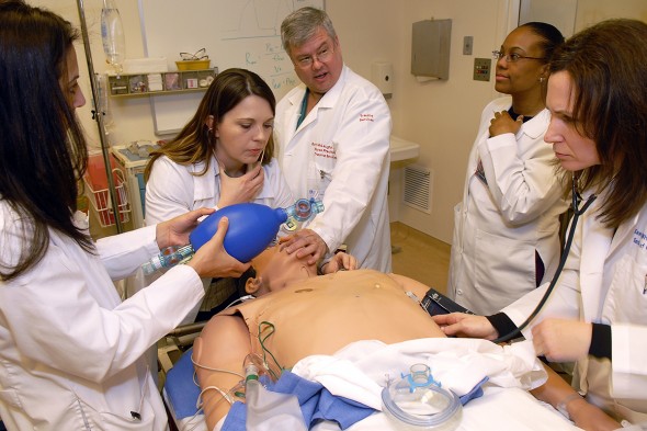 Nursing students learn intubation by working on a mannequin.