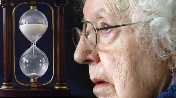 Elderly woman and an hourglass