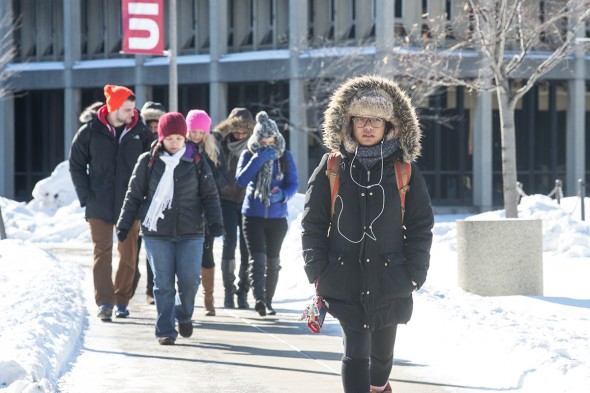 students walking on campus with snow