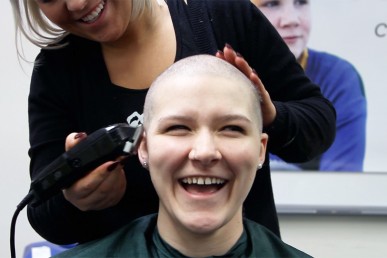 Young woman gets her head shaved