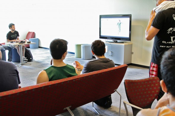 Students watching soccer in a lounge area