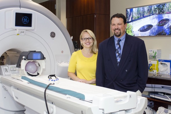 Rachel Jacobs and Scott Langenecker with an MRI machine