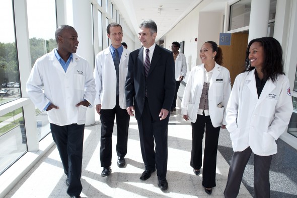 medical students walk with administrator