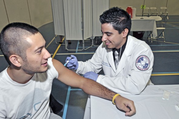 Student Nichola Villanueva recieves a flu shot