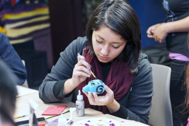 Danielle Nehmer decorating a sugar skull for Day of the Dead
