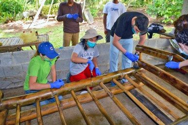 Volunteers painting bamboo