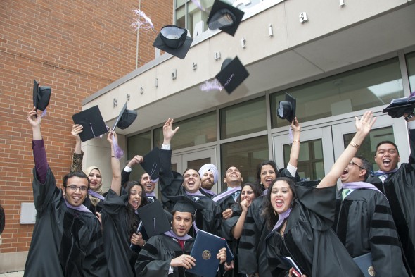 students toss their hats in the air