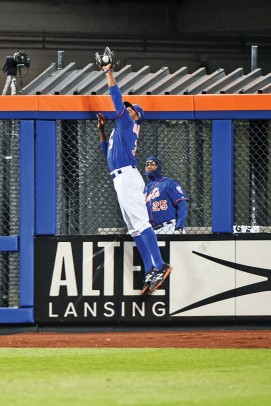 Curtis Granderson leaping to save a home run