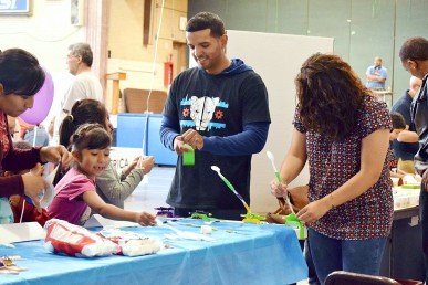 UIC engineering students Cristian Xavier Vargas and Catherine Santis guide young experimenters at a STEM fair. Photo by STARS Project Engineering Academy