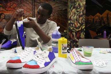 Students decorate shoes for a walk in support of undocumented students.