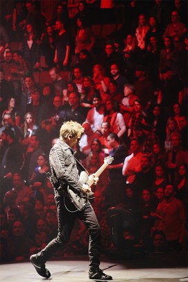 Matt Belamy playing guitar in front of crowd