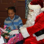 Officer Santa Braulio DeAnda hands out gifts