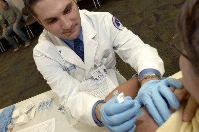 Pharmacy student administers a flu shot