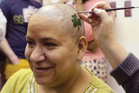 Antonia Pyzik gets a shamrock painted on her freshly-shaved head