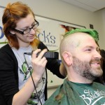 woman shaving a man's head