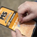 Using a coin to scratch off a lottery ticket