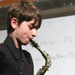 Boy playing saxophone at the jazz workshop