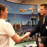 An engineering student networks at job fair