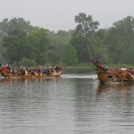 Students race dragon boats on a river