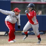 Jenna Marsalli runs as softball coach Michelle Venturella gestures her on