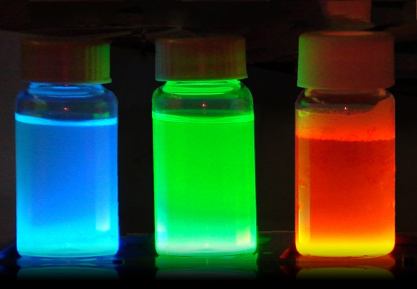 Lab vials containing blue green and orange fluid.