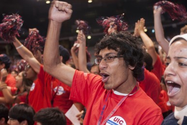 Male student in the crowd cheering