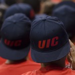 Young man wearing a UIC baseball hat backwards