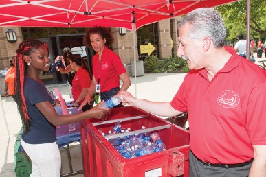 Lon Kaufman gets a bottle of water during move-in
