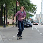 Michael Novak riding his longboard on Halsted Street