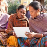 Indian women looking at illustration during a family planning session