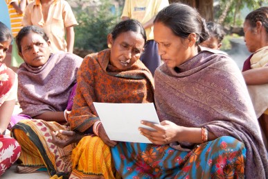 Indian women looking at illustration during a family planning session