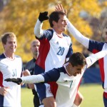 Soccer players celebrate a win