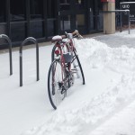 bicycle locked up in the snow