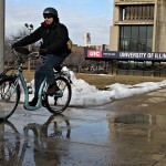 man riding bicycle on campus