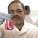 Bellur S. Prabhakar holds a flask of pink liquid