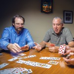 Pat Bauer, Don Arnold, and Craig Skweres playing cards