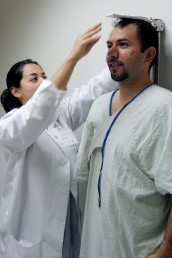 Doctor measures the height of a study participant