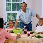 African American family having dinner