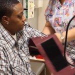 a nurse takes a patient's bloodp pressure