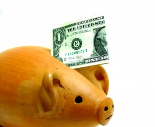 piggy bank with a dollar sticking out of it