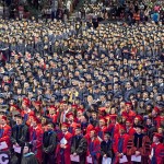 Crowd of graduates standing during ceremony
