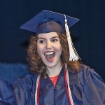Graduate celebrating as she walks across the stage