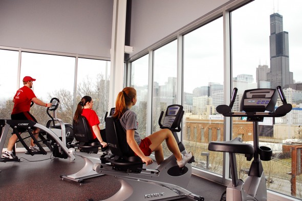 students on exercise machines with a view of the Sears Tower