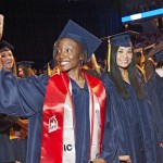 Female graduate waving