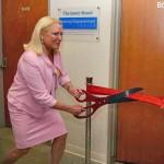 Karen Zupko cutting the ribbon to the therapy room