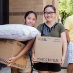 Ottissa Lau and friend Miranda Souvanh carry boxes into the residence hall