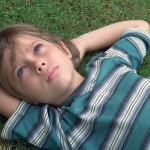 Boy laying in the grass