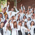 Nursing students wearing white coats